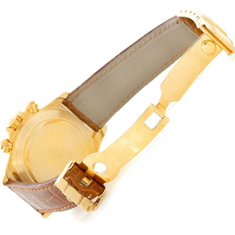 This image shows the underside and clasp of a Rolex Daytona 16518 Men's Yellow Gold White Dial 16518 Men's Yellow Gold White Dial watch, highlighting its gold hardware and leather strap.