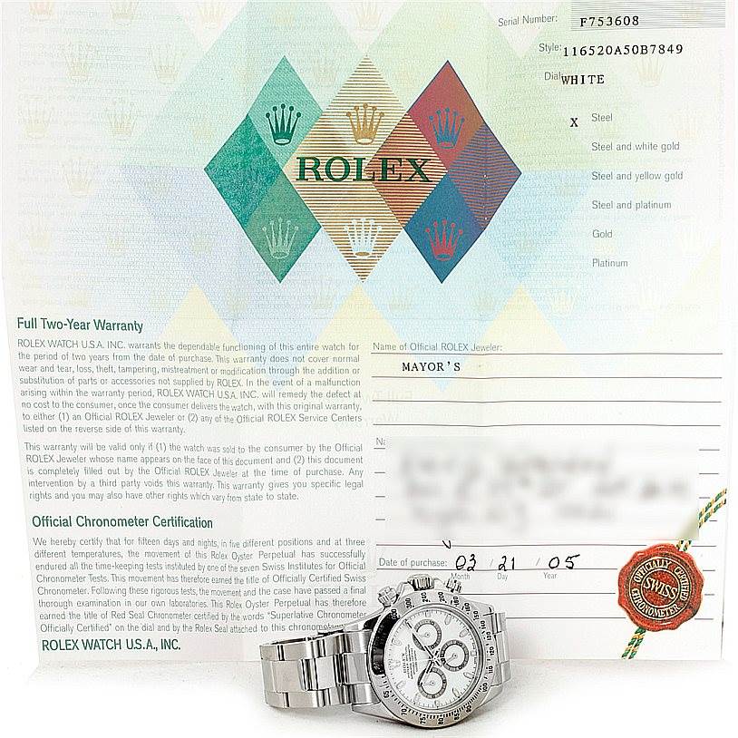 The image shows a Rolex Daytona 116520 Men
s Stainless Steel White Dial 116520 Men
s Stainless Steel White Dial watch, photographed from the front, placed on its warranty document.