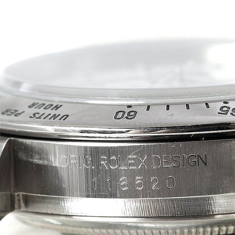 This image shows a close-up of the bezel and case side of a Rolex Daytona 116520 Men
s Stainless Steel White Dial 116520 Men
s Stainless Steel White Dial watch with the model number 116520.