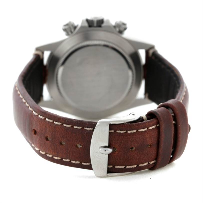 The image shows the back of a Rolex Daytona 116520 Men's Stainless Steel White Dial 116520 Men's Stainless Steel White Dial watch with a brown leather strap and buckle.