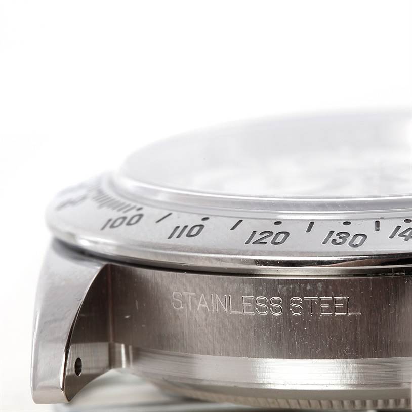 The image shows a close-up side angle of the bezel and case of a Rolex Daytona 116520 Men's Stainless Steel White Dial 116520 Men's Stainless Steel White Dial model watch, highlighting the stainless steel material.