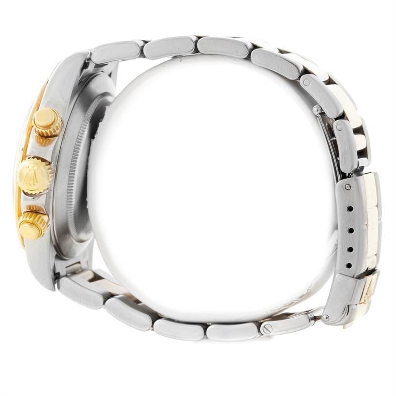 This side view of the Rolex Daytona 16523 Men's Steel and Gold (two tone) White Dial 16523 Men's Steel and Gold (two tone) White Dial watch highlights its band, crown, and pushers.