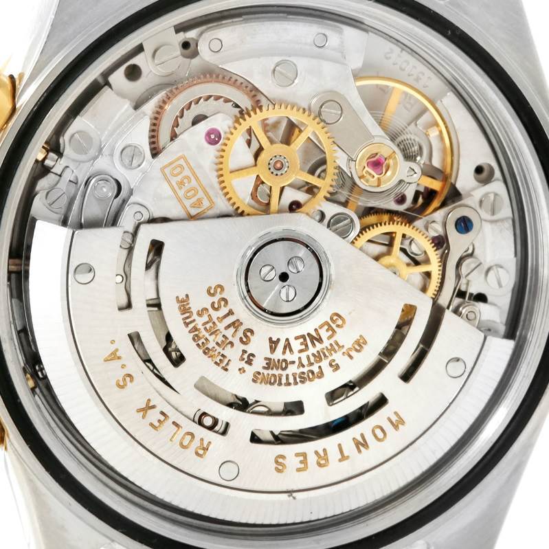 This image shows the intricate movement and inner workings of the Rolex Daytona 16523 Men's Steel and Gold (two tone) White Dial 16523 Men's Steel and Gold (two tone) White Dial watch from a close-up, rear angle.