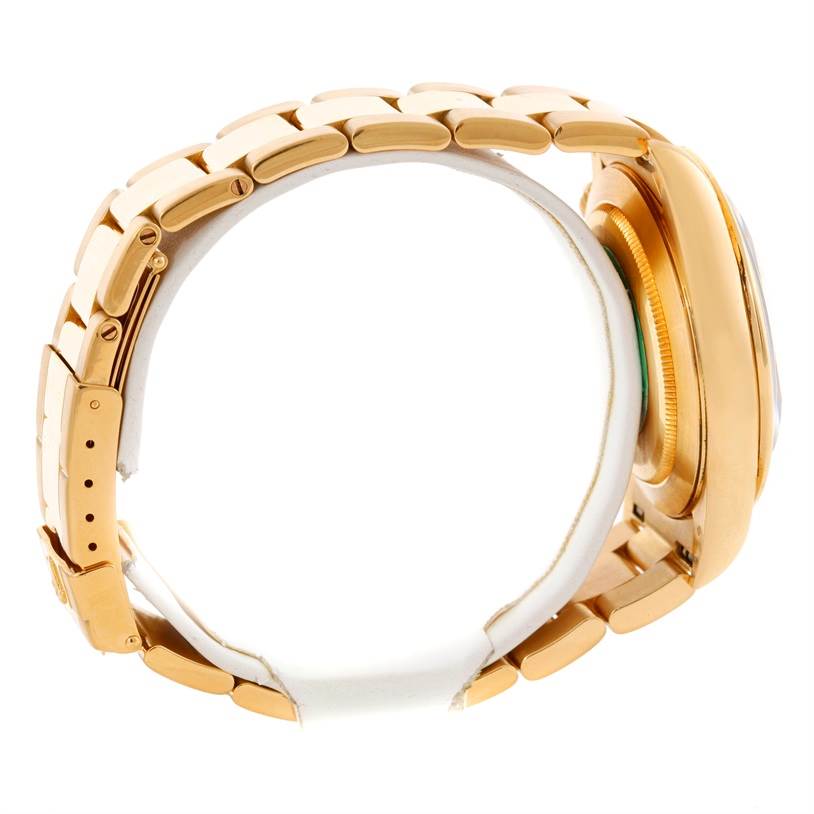 This image shows a side view of a yellow gold Rolex Daytona Men's Yellow Gold Black Dial Men's Yellow Gold Black Dial watch, focusing on the band and case.