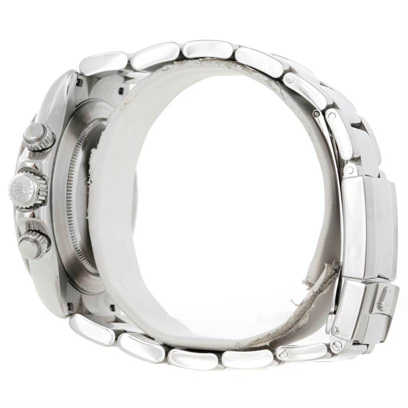 The image shows a side view of a Rolex Daytona 116520 Men's Stainless Steel White Dial 116520 Men's Stainless Steel White Dial watch, highlighting the crown, pushers, case, and bracelet.