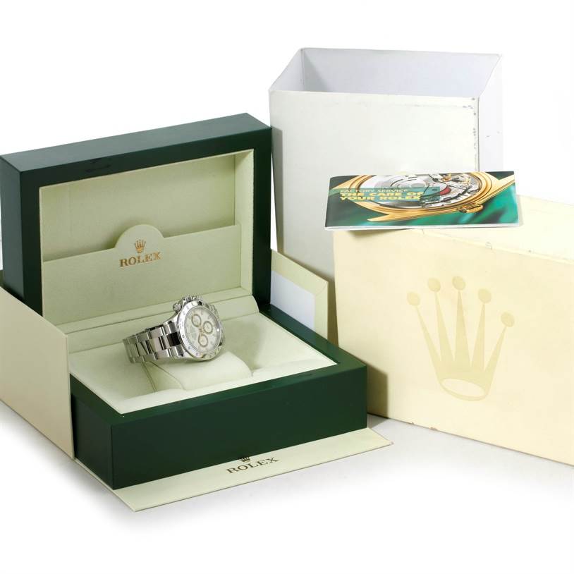 The Rolex Daytona 116520 Men's Stainless Steel White Dial 116520 Men's Stainless Steel White Dial watch is shown in its open box with additional packaging and a card in the background.
