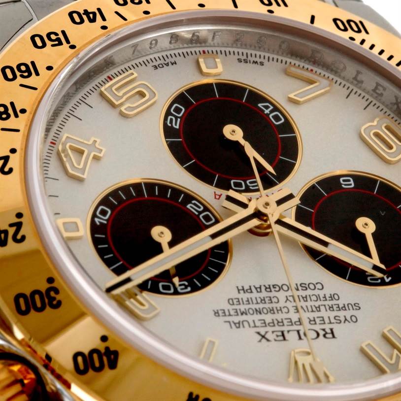 The image shows a close-up angle of the Rolex Daytona 116523 Men's Steel and Gold (two tone) White Dial 116523 Men's Steel and Gold (two tone) White Dial watch, highlighting the bezel, dial, and subdials.