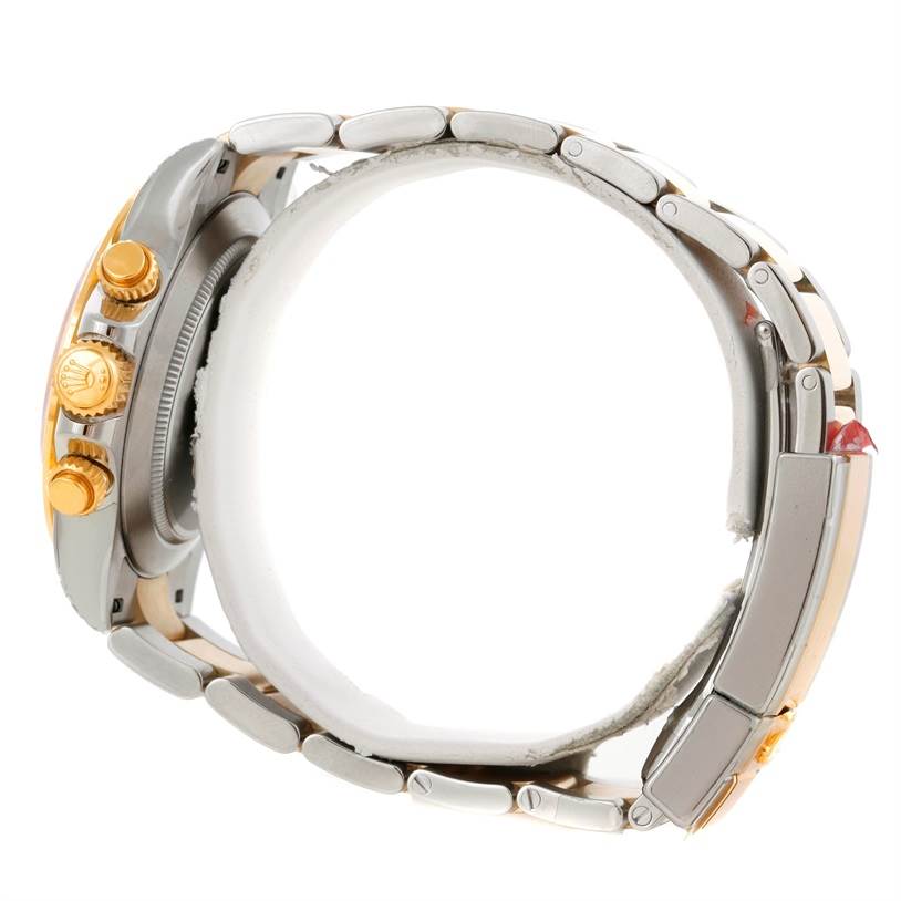 This side view of the Rolex Daytona 116523 Men's Steel and Gold (two tone) White Dial 116523 Men's Steel and Gold (two tone) White Dial watch shows the crown, pushers, and part of the bracelet.