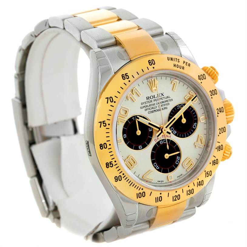The image shows a Rolex Daytona 116523 Men's Steel and Gold (two tone) White Dial 116523 Men's Steel and Gold (two tone) White Dial watch from an oblique angle, displaying the face, bezel, case, and part of the bracelet.
