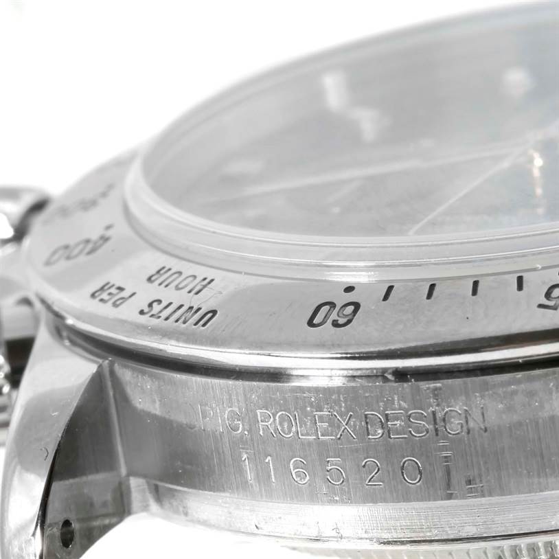 This close-up image shows the side profile of a Rolex Daytona 116520 Men's Stainless Steel Black Dial 116520 Men's Stainless Steel Black Dial watch, highlighting the bezel, case, and engraved model number.