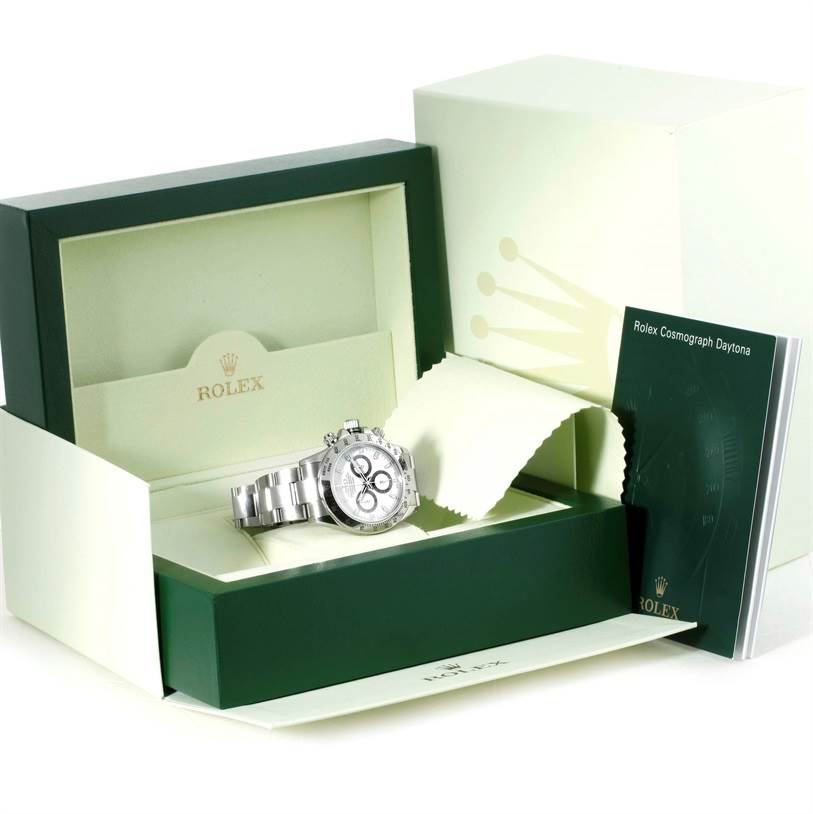The image shows a Rolex Daytona 116520 Men's Stainless Steel White Dial 116520 Men's Stainless Steel White Dial watch in its opened box with accompanying booklet and cleaning cloth.