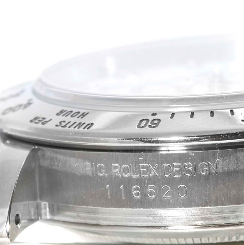 The image shows a close-up angled view of the side of the Rolex Daytona 116520 Men's Stainless Steel White Dial 116520 Men's Stainless Steel White Dial watch, highlighting the bezel and model number engraving.