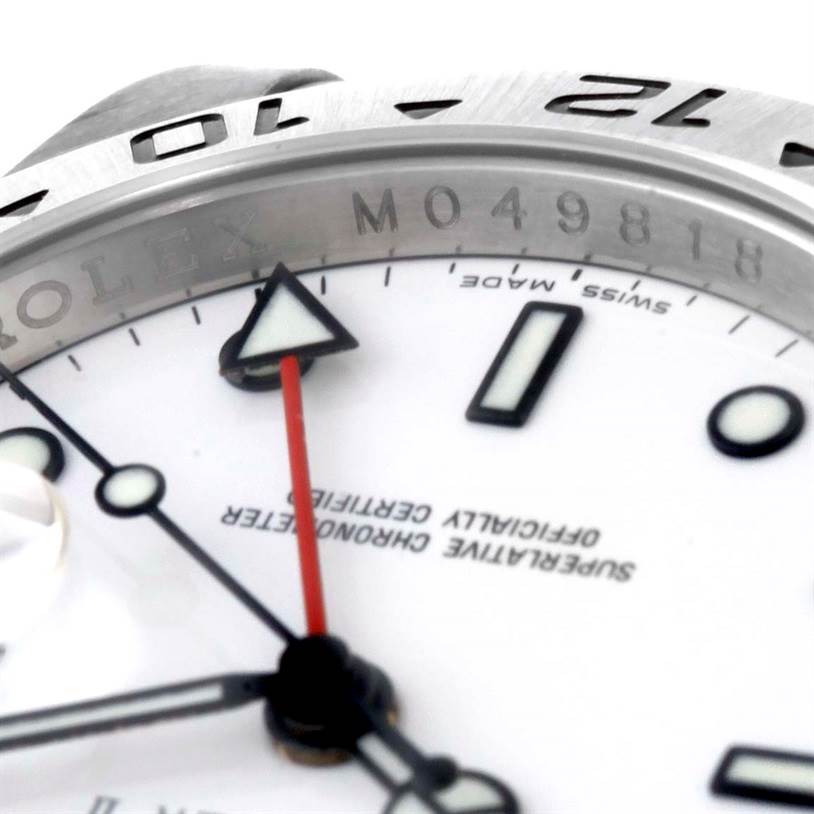 This close-up angle of the Rolex Explorer 16570 Men's Stainless Steel White Dial 16570 Men's Stainless Steel White Dial watch shows the bezel, a portion of the dial, and the hands.