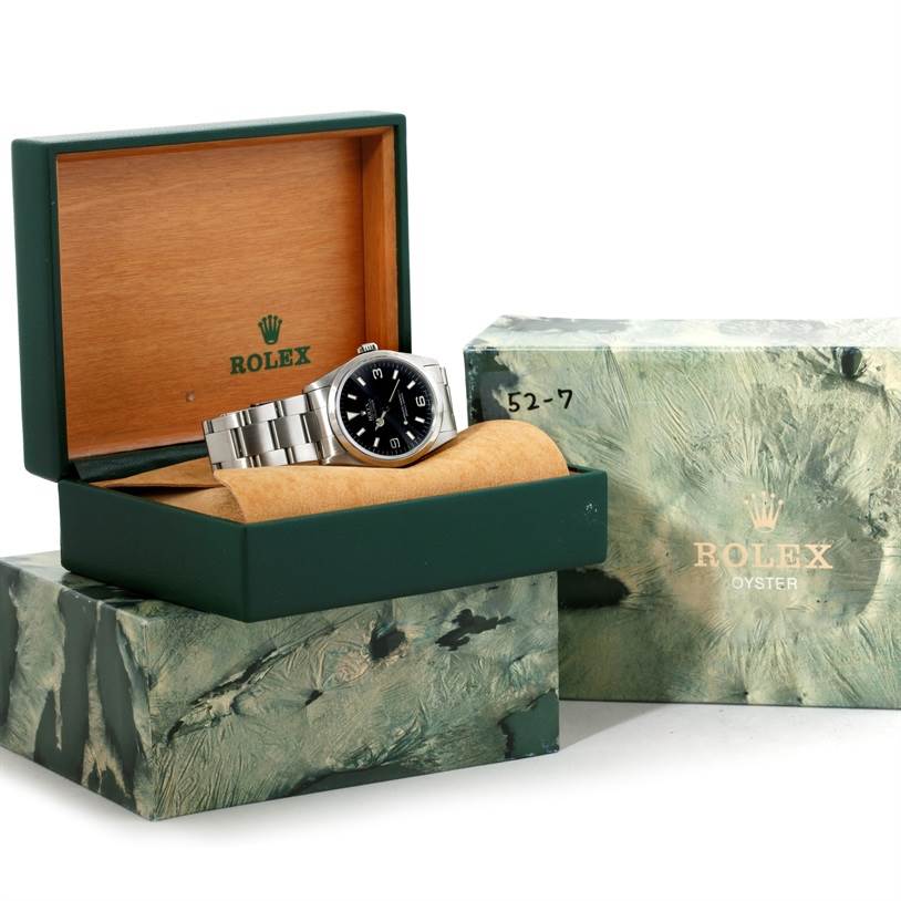 The Rolex Explorer 14270 Men's Stainless Steel Black Dial 14270 Men's Stainless Steel Black Dial watch is displayed inside its open box, along with the outer box beside it.