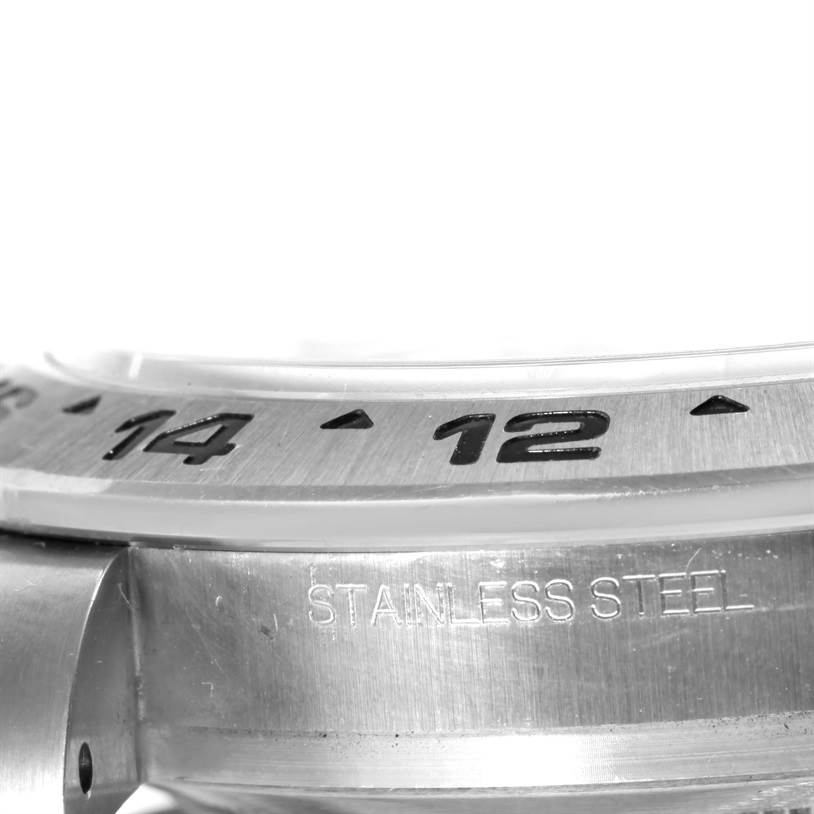 This image shows a close-up, angled view of the bezel and part of the case of a Rolex Explorer 216570 Men
s Stainless Steel White Dial 216570 Men
s Stainless Steel White Dial watch, highlighting the stainless steel material.