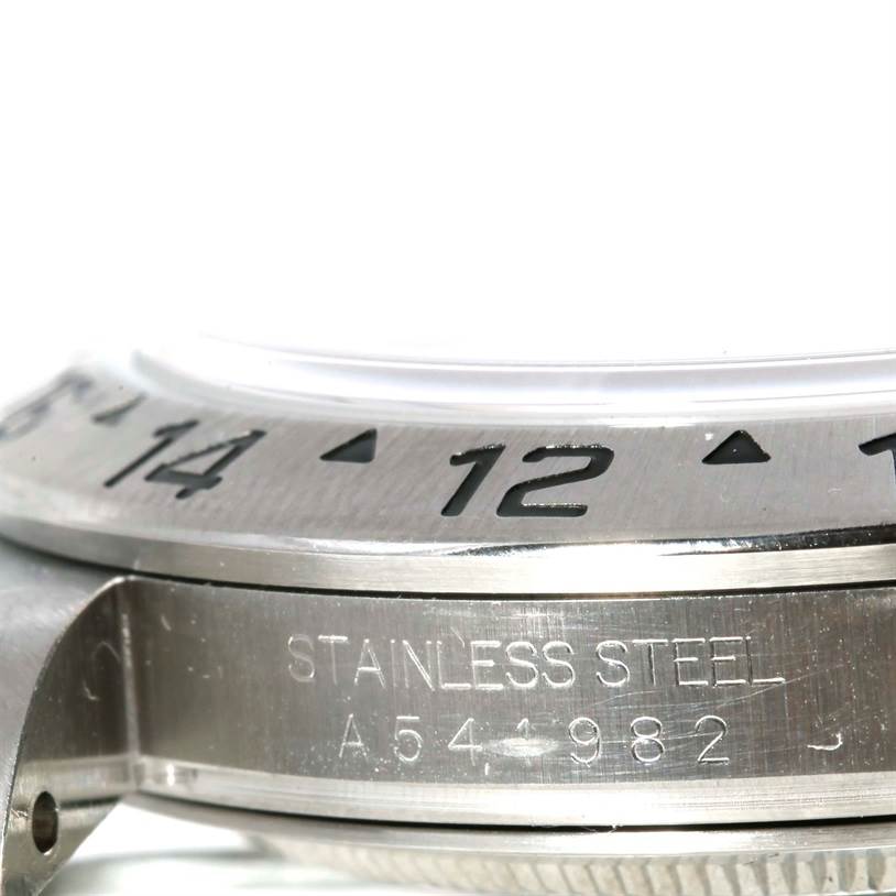 This image shows a close-up side view of the bezel and stainless steel casing of a Rolex Explorer 16570 Men's Stainless Steel White Dial 16570 Men's Stainless Steel White Dial watch.