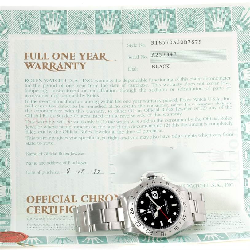 The image shows a Rolex Explorer 16570 Men's Stainless Steel Black Dial 16570 Men's Stainless Steel Black Dial model watch positioned diagonally with its face, bezel, and bracelet visible, along with a warranty certificate.