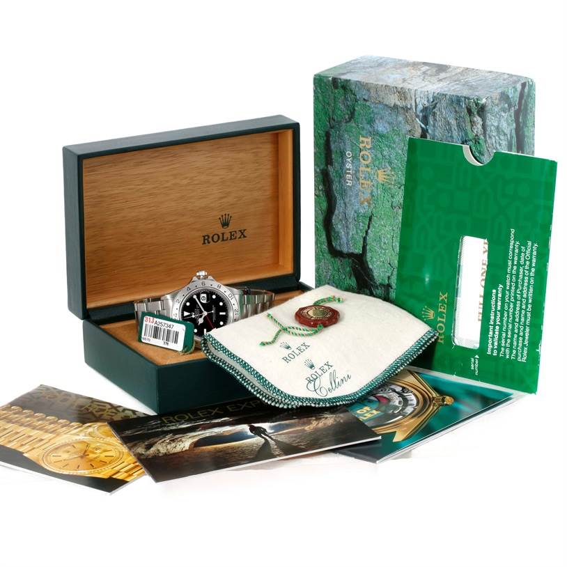 The image shows a Rolex Explorer 16570 Men's Stainless Steel Black Dial 16570 Men's Stainless Steel Black Dial watch in its open box, along with warranty card, booklet, tag, and cloth pouch from an overhead angle.