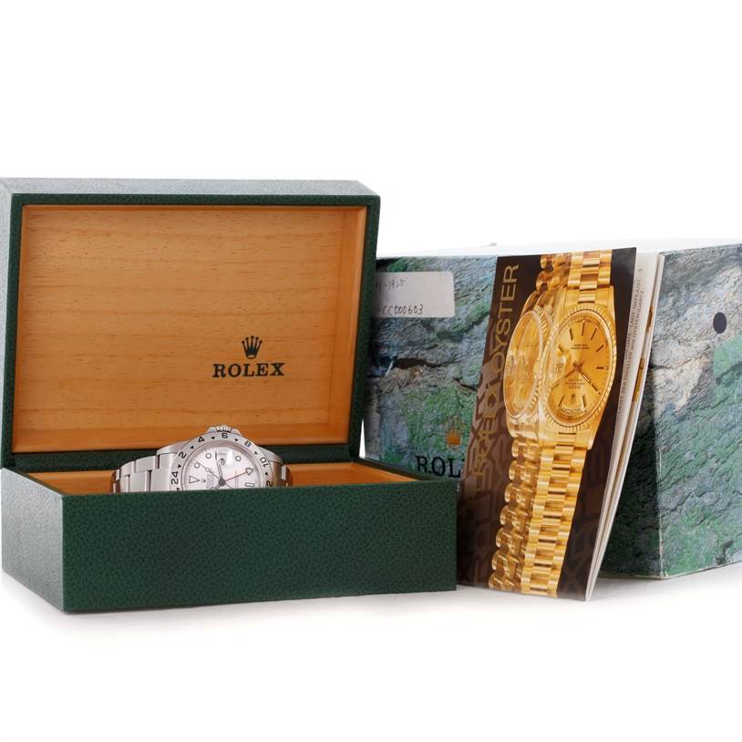 The image shows a Rolex Explorer 16570 Men's Stainless Steel White Dial 16570 Men's Stainless Steel White Dial watch partially inside an open Rolex box, with accompanying brochures and outer packaging visible.