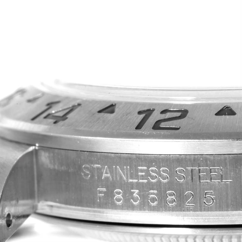 The image shows a close-up of the side of a Rolex Explorer 16570 Men's Stainless Steel White Dial 16570 Men's Stainless Steel White Dial watch, highlighting the bezel and the "STAINLESS STEEL" engraving.