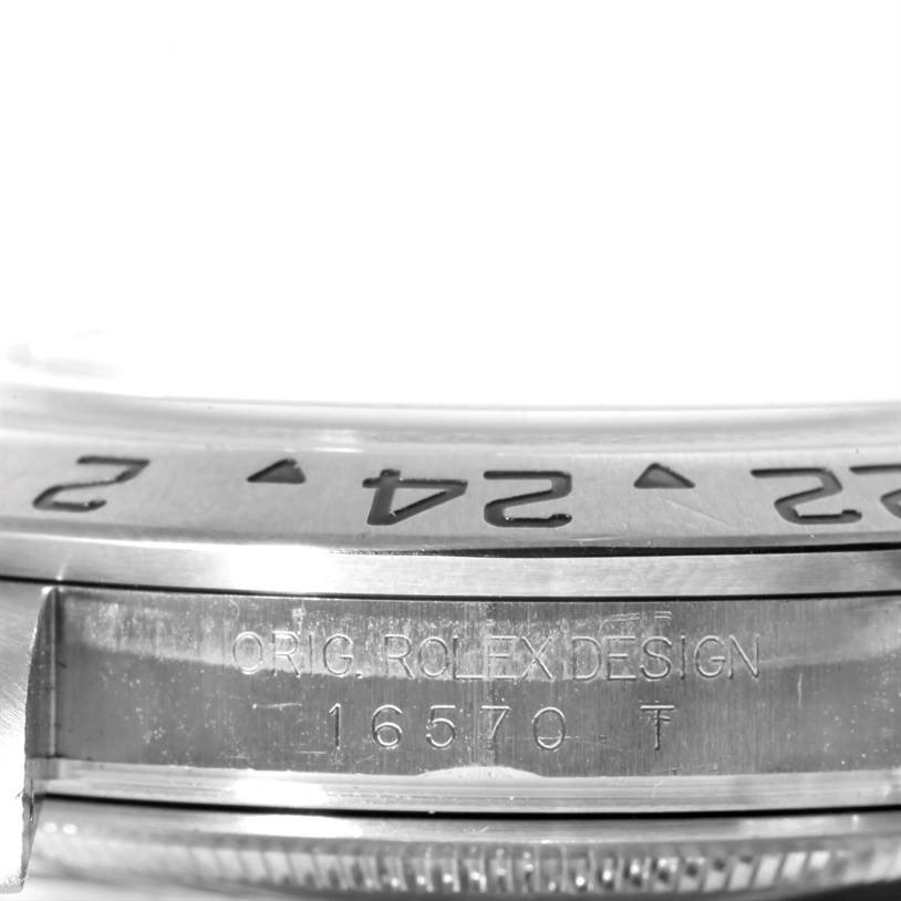 The image shows a close-up of the side of a Rolex Explorer 16570 Men's Stainless Steel Black Dial 16570 Men's Stainless Steel Black Dial watch, displaying the model number 16570 and part of the bezel.