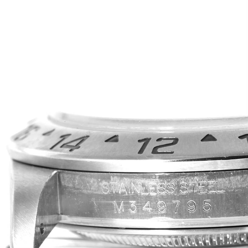 The image shows a close-up of the bezel and side view of the case with serial number engraving on a Rolex Explorer 16570 Men's Stainless Steel Black Dial 16570 Men's Stainless Steel Black Dial watch.