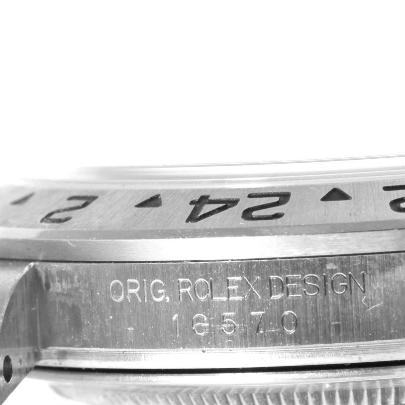 This image shows a close-up view of the side and bezel of a Rolex Explorer 16570 Men's Stainless Steel White Dial 16570 Men's Stainless Steel White Dial watch, displaying the model number and "ORIG. ROLEX DESIGN" inscription.