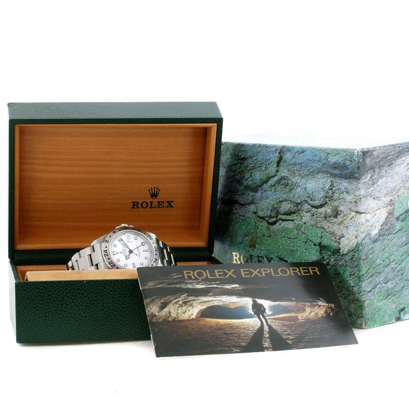 The Rolex Explorer 16570 Men's Stainless Steel White Dial 16570 Men's Stainless Steel White Dial watch is shown at an angle inside an open green Rolex box, next to a branded booklet and outer box.