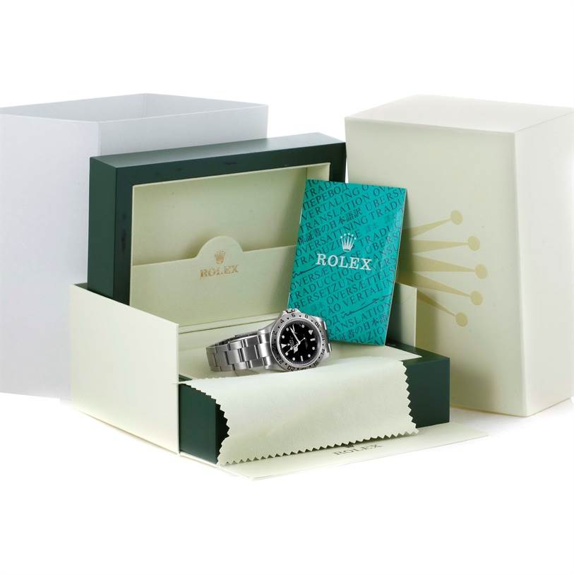 The image shows a Rolex Explorer 16570 Men's Stainless Steel Black Dial 16570 Men's Stainless Steel Black Dial watch, its box, warranty card, and cleaning cloth viewed from an angled front perspective.
