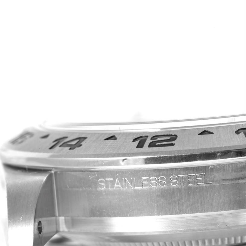 This close-up image shows the stainless steel bezel and part of the case of the Rolex Explorer 216570 Men
s Stainless Steel Black Dial 216570 Men
s Stainless Steel Black Dial model, highlighting the numbers and material engraving.