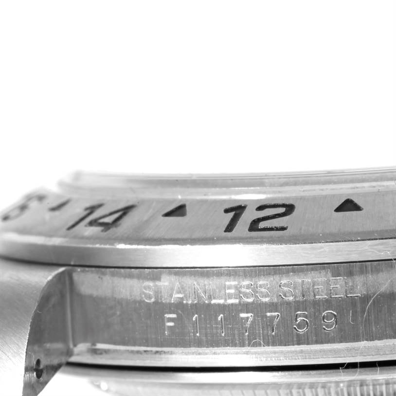 The image shows a side view of the bezel and case of a Rolex Explorer 16570 Men's Stainless Steel White Dial 16570 Men's Stainless Steel White Dial watch, displaying time markers and the stainless steel engraving.