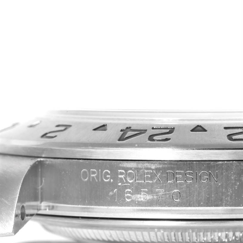This image shows a side view of a Rolex Explorer 16570 Men's Stainless Steel White Dial 16570 Men's Stainless Steel White Dial watch's bezel and engraved watch casing.
