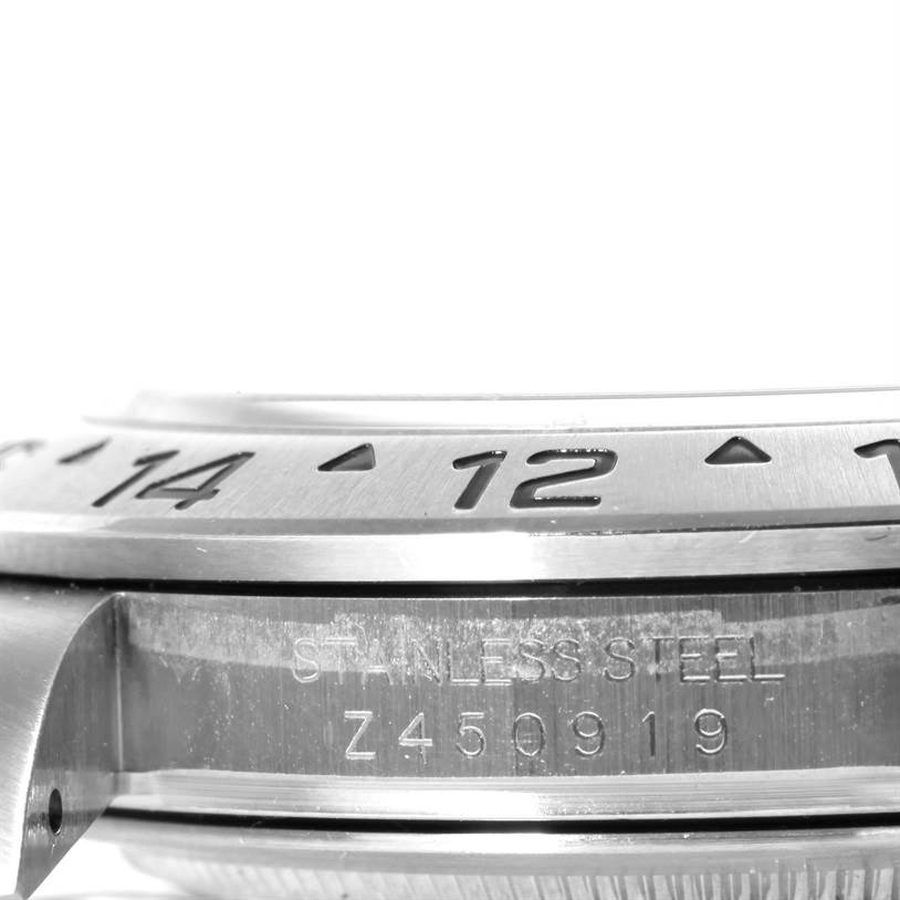 The image displays a close-up side view of the bezel and case of a Rolex Explorer 16570 Men's Stainless Steel Black Dial 16570 Men's Stainless Steel Black Dial watch, focusing on the stainless steel and engraved details.