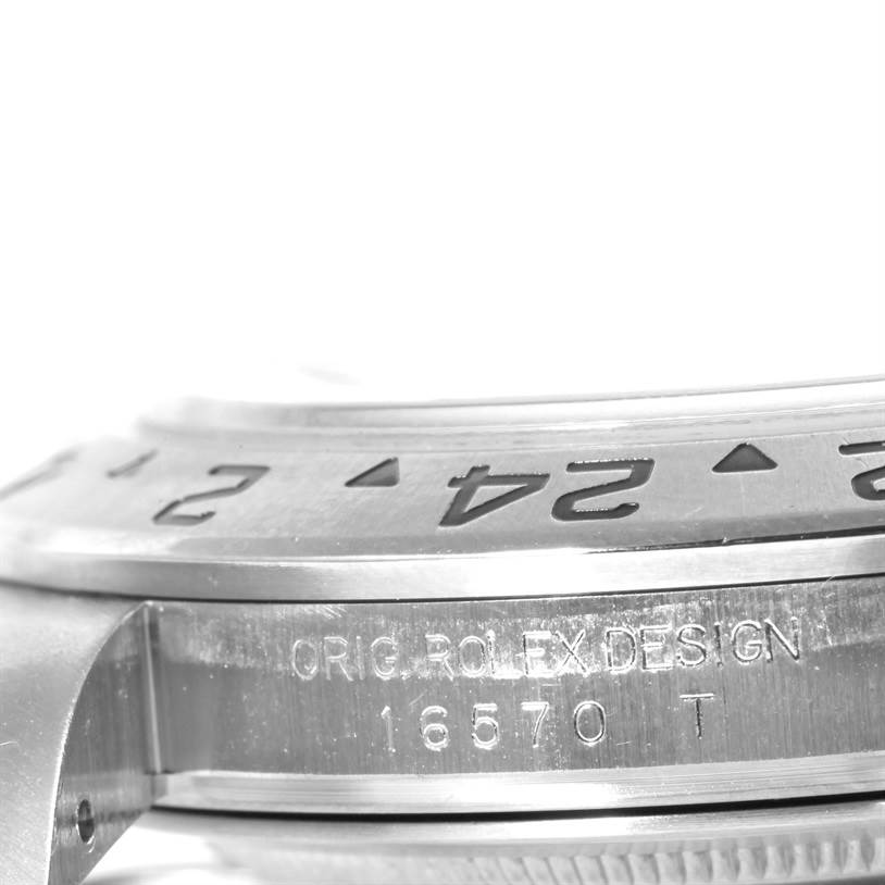 The image shows a close-up of the Rolex Explorer 16570 Men's Stainless Steel Black Dial 16570 Men's Stainless Steel Black Dial model, focusing on the side of the case with engraved markings and bezel.