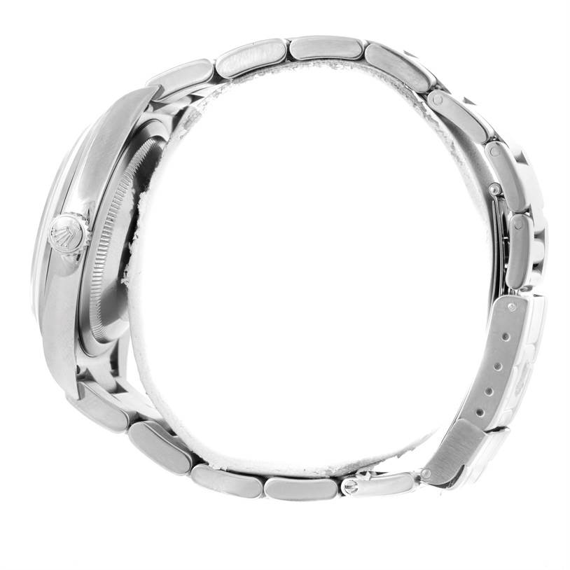 This side view of the Rolex Explorer 114270 Men's Stainless Steel Black Dial 114270 Men's Stainless Steel Black Dial watch displays its case, crown, and bracelet with a closed clasp.