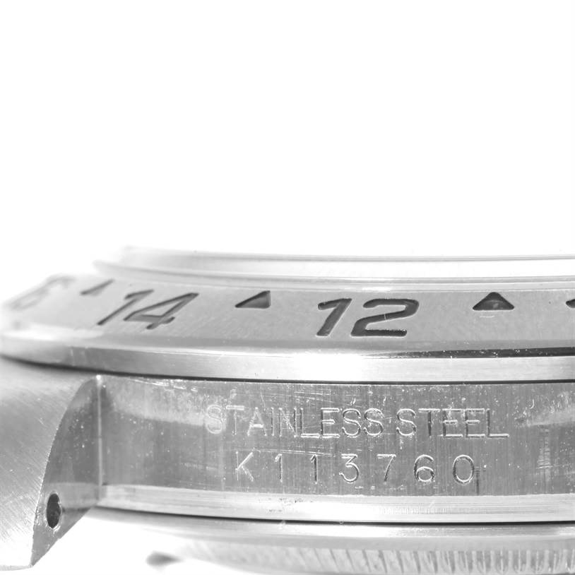 This close-up image shows the bezel and case side of a Rolex Explorer 16570 Men's Stainless Steel White Dial 16570 Men's Stainless Steel White Dial watch, featuring the stainless steel engraving.