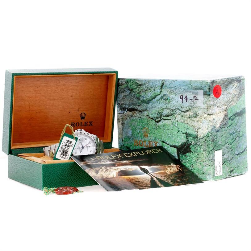 The image shows a Rolex Explorer 16570 Men's Stainless Steel White Dial 16570 Men's Stainless Steel White Dial watch along with its open box, manuals, and outer packaging.