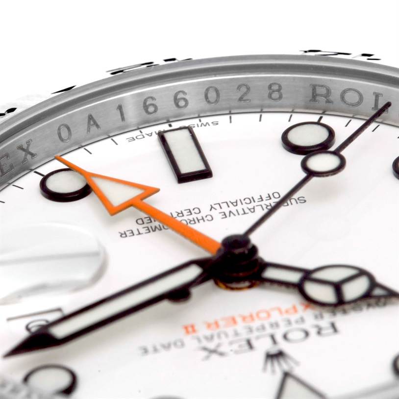 Close-up of the dial and hands of a Rolex Explorer 216570 Men's Stainless Steel White Dial 216570 Men's Stainless Steel White Dial watch, showing part of the case and the inscription.