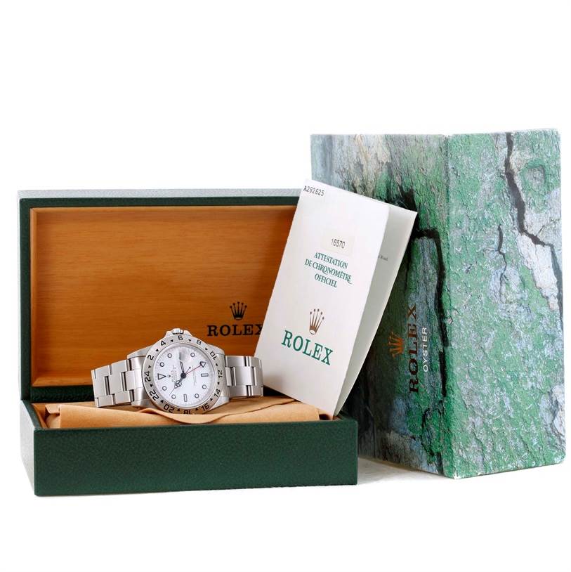 The Rolex Explorer 16570 Men's White Dial 16570 Men's White Dial watch is shown in its open box with the instruction manual and outer packaging visible.