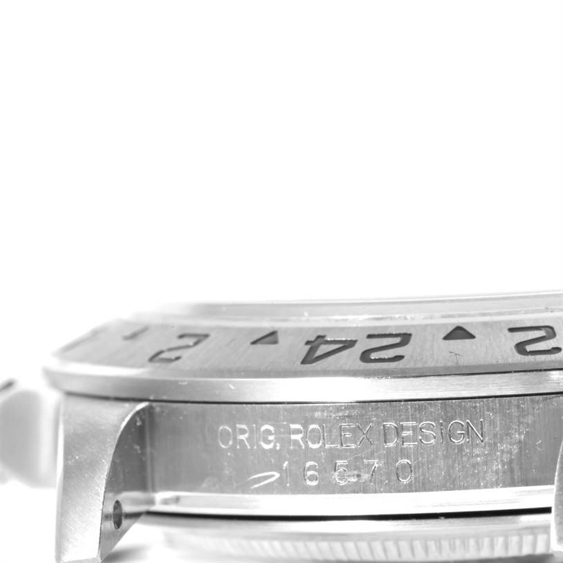 The image shows a side view of the bezel and case of a Rolex Explorer 16570 Men's White Dial 16570 Men's White Dial watch, highlighting the engraved design and model number.