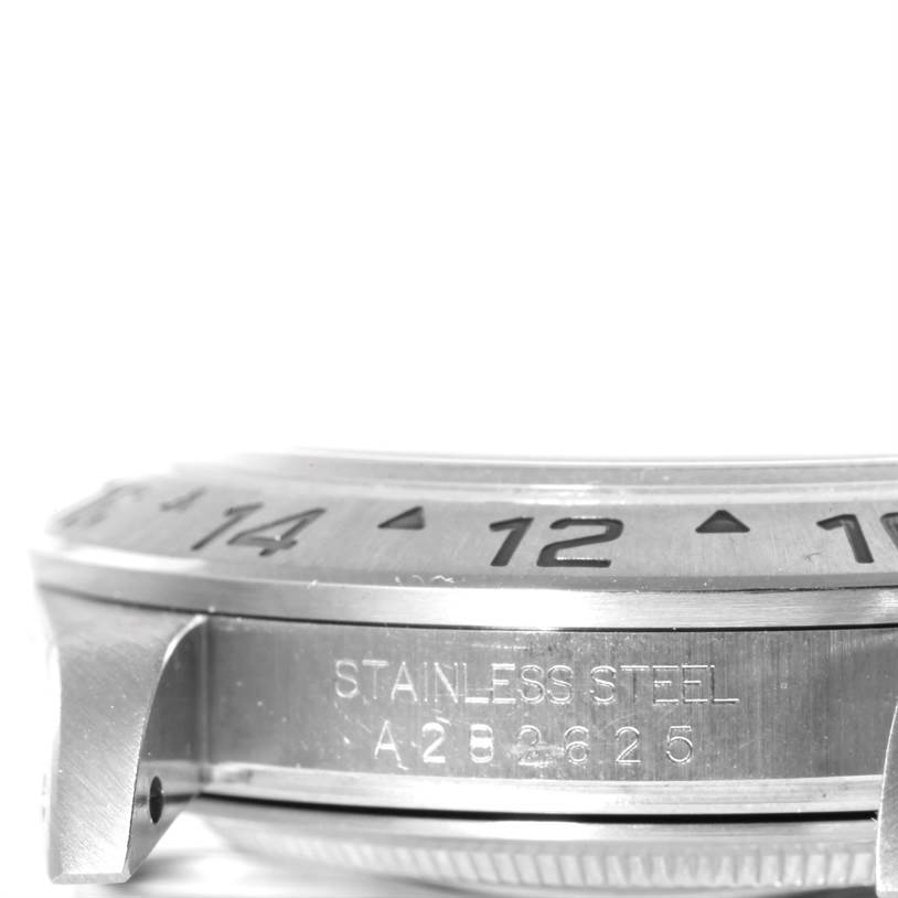 The image shows a close-up side view of the bezel and lugs of a Rolex Explorer 16570 Men's White Dial 16570 Men's White Dial watch, highlighting the stainless steel casing and engraved markings.