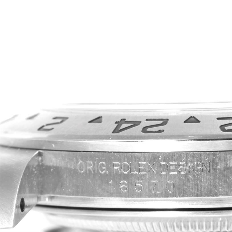 This image shows an angled close-up of the bezel and part of the case of a Rolex Explorer 16570 Men's Stainless Steel White Dial 16570 Men's Stainless Steel White Dial watch.