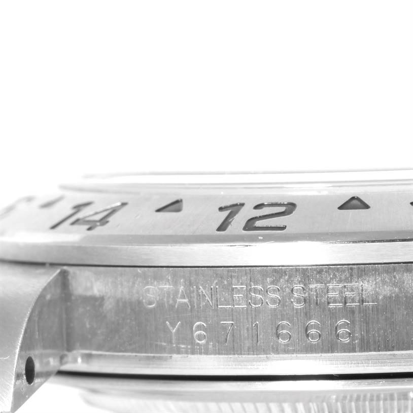 This image shows a close-up side view of the bezel and case of a Rolex Explorer 16570 Men's Stainless Steel White Dial 16570 Men's Stainless Steel White Dial watch, highlighting the stainless steel marking and partial serial number.