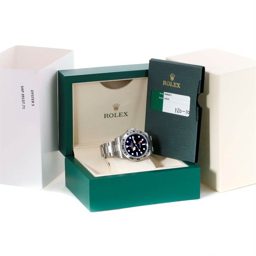 The image shows a Rolex Explorer 216570 Men's Stainless Steel Black Dial 216570 Men's Stainless Steel Black Dial model watch from an angled view, displayed in its box alongside its warranty card and packaging.