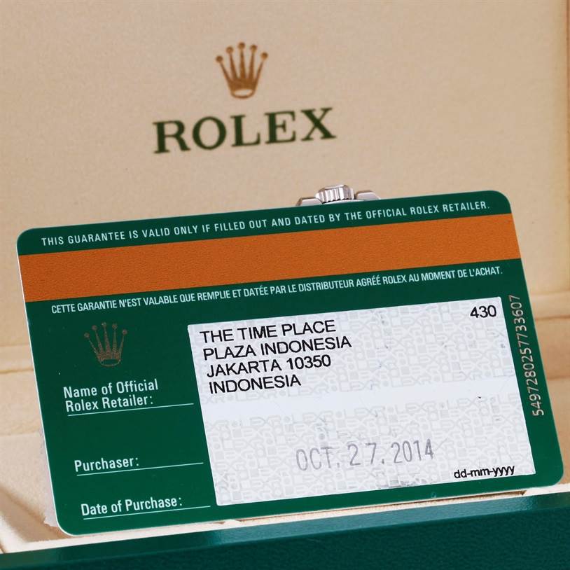 The image shows the warranty card for a Rolex Explorer 216570 Men's Stainless Steel Black Dial 216570 Men's Stainless Steel Black Dial, along with part of its packaging.