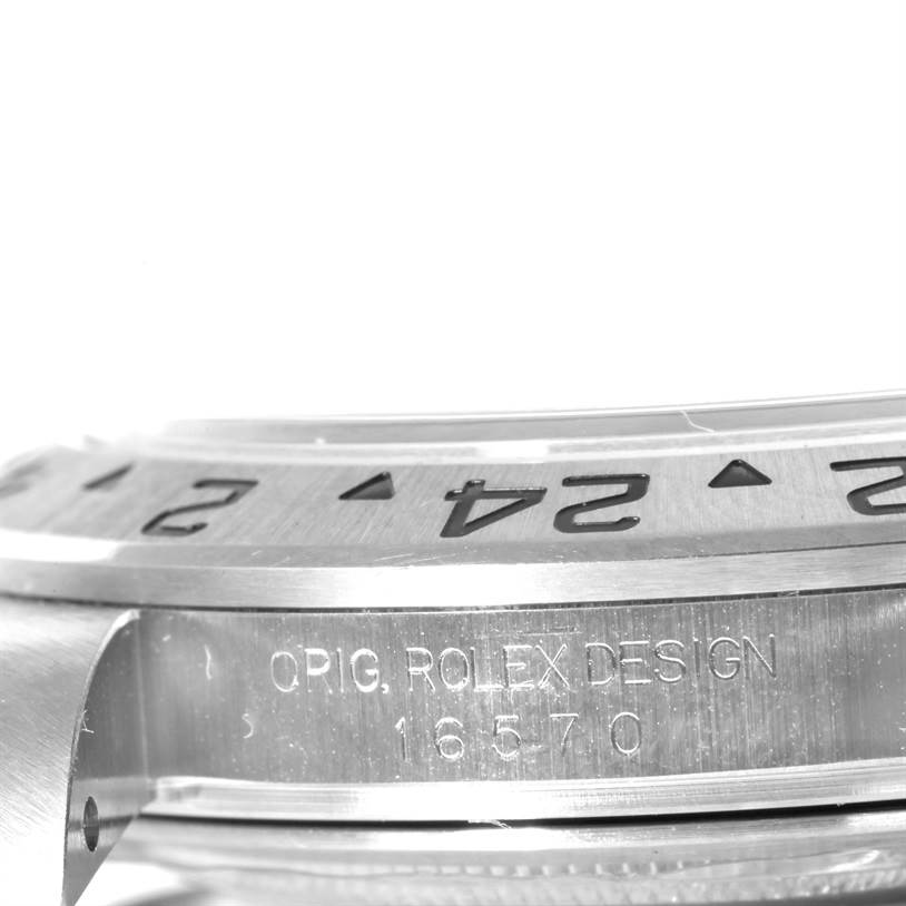 This image shows a close-up side view of the bezel and case of a Rolex Explorer 16570 Men's Stainless Steel White Dial 16570 Men's Stainless Steel White Dial watch, highlighting the engraved model number.