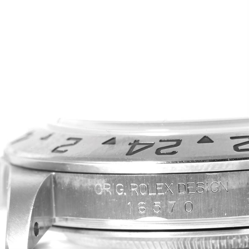 The image shows a side angle view of a Rolex Explorer 16570 Men
s Stainless Steel White Dial 16570 Men
s Stainless Steel White Dial watch with the model number 16570 engraved on the case.