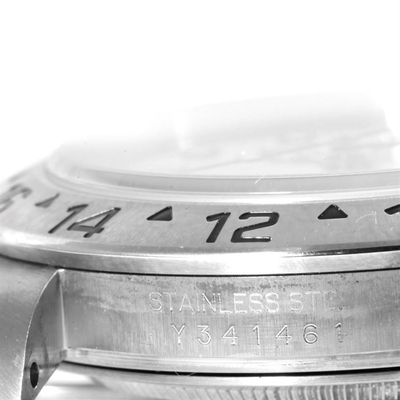 This image shows a close-up of the bezel and case of a Rolex Explorer 16570 Men
s Stainless Steel White Dial 16570 Men
s Stainless Steel White Dial watch with the "STAINLESS STEEL" engraving visible.