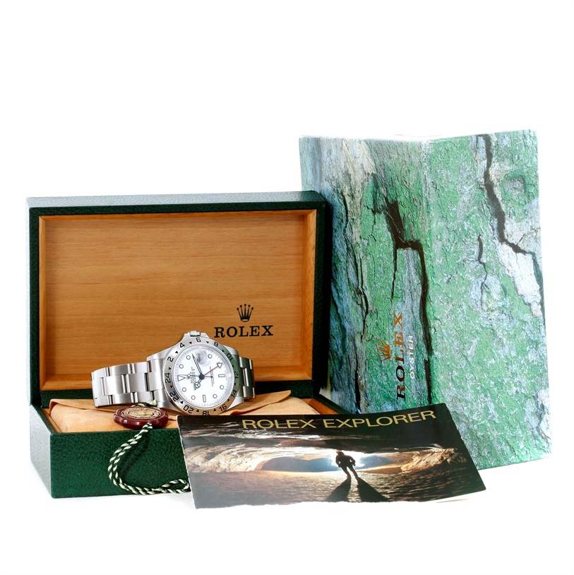 The image shows a Rolex Explorer 16570 Men
s Stainless Steel White Dial 16570 Men
s Stainless Steel White Dial watch, its open box, a booklet, and outer packaging from a front angle.
