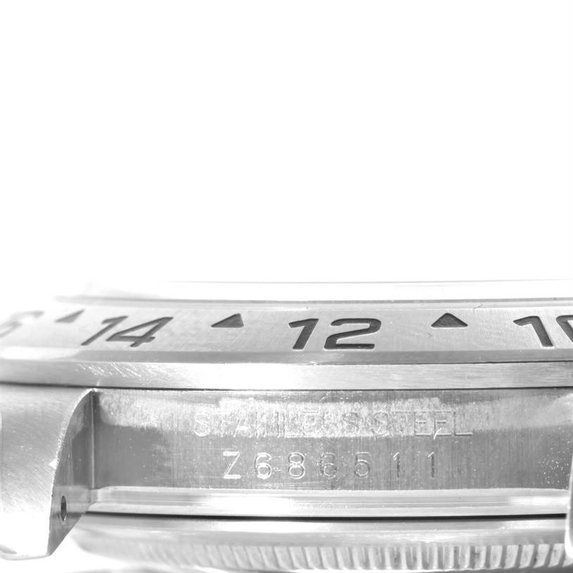 This image shows a close-up of the side profile of a Rolex Explorer 16570 Men's Stainless Steel White Dial 16570 Men's Stainless Steel White Dial watch, highlighting the bezel with numbers and part of the watch case and lug.